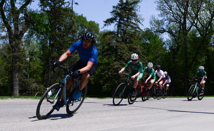Evan Biebrich leads the bunch into a turn at the 2026 Manitoba Provincial Criterium Championships at the 2026 Tour de Riding Mountain. Photo Gregory McNeill.